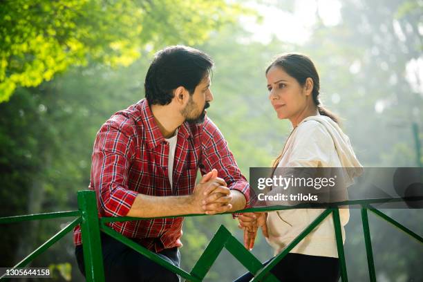 couple spending leisure time at park - serious couple stock pictures, royalty-free photos & images
