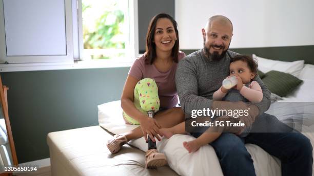 portrait of a family at home (including a disability mother) - amputee home stock pictures, royalty-free photos & images