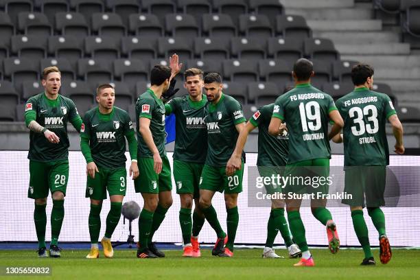 Laszlo Benes of FC Augsburg celebrates with team mates after scoring their side's first goal during the Bundesliga match between Hertha BSC and FC...