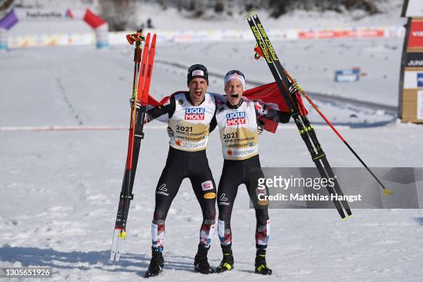 Johannes Lamparter of Austria and Lukas Greiderer of Austria celebrate after winning the Men's Nordic Combined Team HS137/4x7.5 Km at the FIS Nordic...