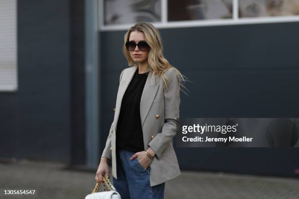 Scarlett Gartmann wearing Chanel white bag and Chanel black boots, Saint Laurent blazer, Gucci black shades, The Frankie Shop black Shirt and Bershka...