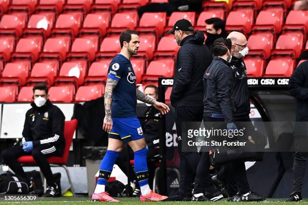 Danny Ings of Southampton walks off injured past Ralph Hasenhuettl, Manager of Southampton during the Premier League match between Sheffield United...
