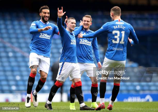 Ryan Kent of Rangers celebrates with teammates Connor Goldson, Steven Davis and Borna Barisic after scoring their team's first goal during the...