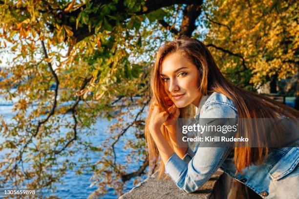 woman enjoying sunrise by a riverbank - sept bildbanksfoton och bilder