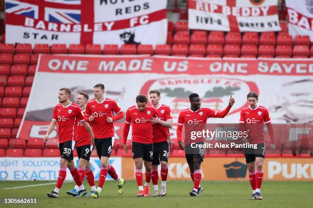 Daryl Dike of Barnsley FC celebrates with teammates after scoring their team's first goal during the Sky Bet Championship match between Barnsley and...