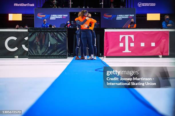 Rianne de Vries, Suzanne Schulting and Yara van Kerkhof of Netherlands hug in memory of Lara Van Ruijven after the Ladies 500m medal ceremony during...