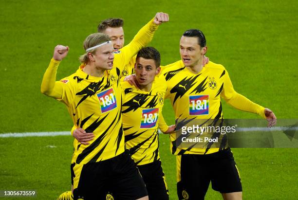 Erling Haaland of Borussia Dortmund celebrates with teammates Thorgan Hazard and Nico Schulz after scoring their team's second goal during the...