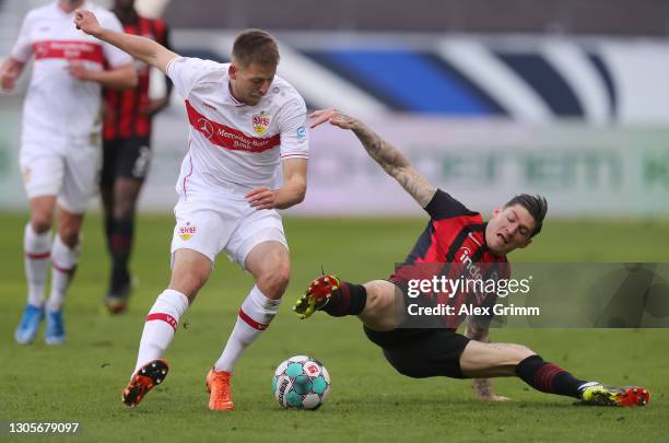 Waldemar Anton of Stuttgart is challenged by Steven Zuber of Frankfurt during the Bundesliga match between Eintracht Frankfurt and VfB Stuttgart at...