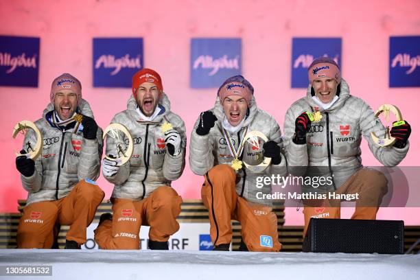 Pius Paschke , Markus Eisenbichler, Severin Freund and Karl Geiger of Germany with gold medal, during the medal ceremony for the Men's Ski Jumping...