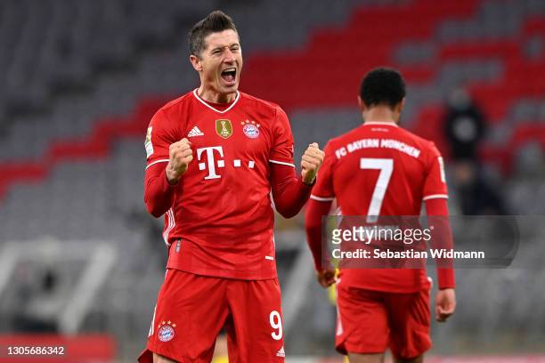 Robert Lewandowski of FC Bayern Muenchen celebrates after scoring their side's fourth goal, completing his hat-trick during the Bundesliga match...