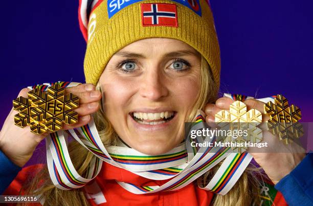 Therese Johaug of Norway poses with all her gold medals during the medal ceremony of the Women's Cross Country 30km Mass Start Classic at the FIS...