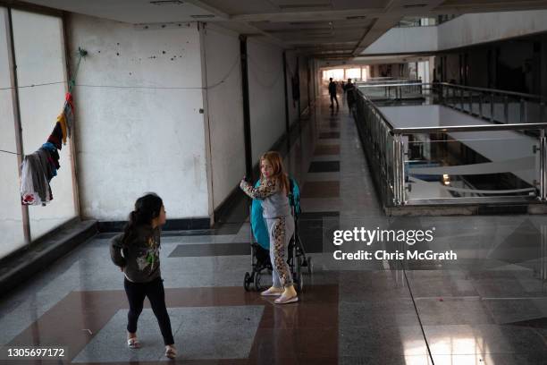 Girls play in the corridor outside their homes on the empty fourth floor of a shopping mall on March 06, 2021 in Erbil, Iraq. In 2014 when ISIS...