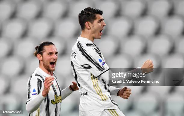 Alvaro Morata of Juventus celebrates with Adrien Rabiot after scoring their team's third goal from the penalty spot during the Serie A match between...