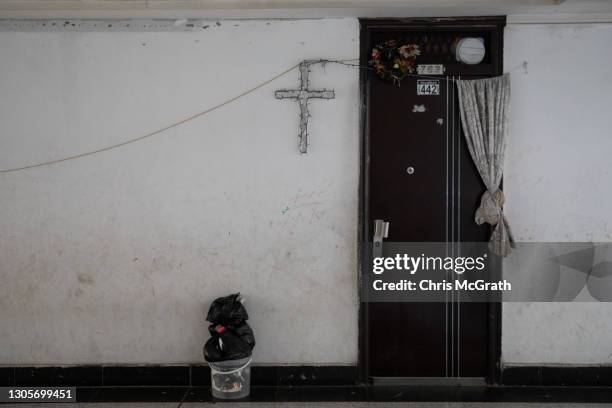 Cross is seen at the entrance to a Christian families temporary home on the empty fourth floor of a shopping mall on March 06, 2021 in Erbil, Iraq....