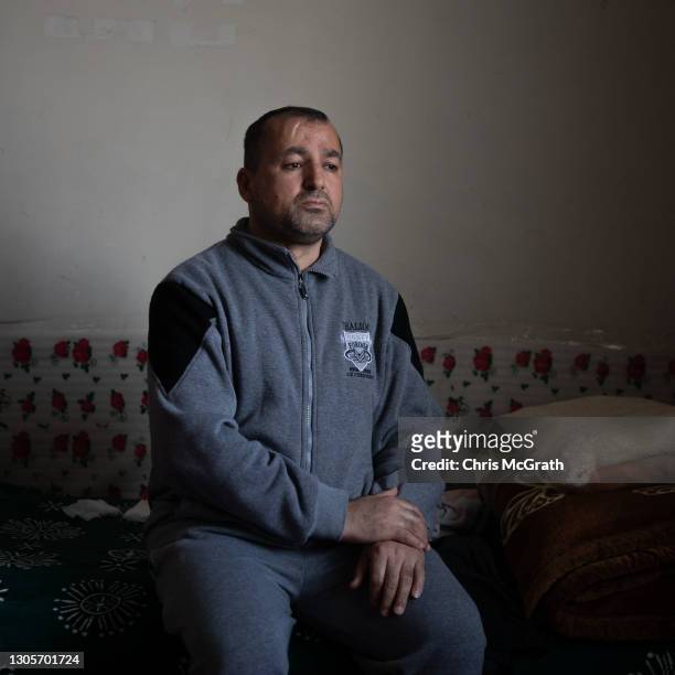 Ryadh Noail Jjlias who fled his home in Qaraqosh in 2014, poses for a portrait in his temporary home on the empty fifth floor of a shopping mall on...
