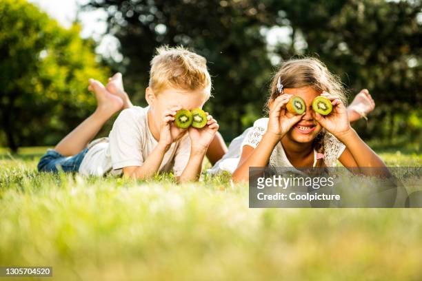 children with binoculars on a meadow - girl 6 7 stock pictures, royalty-free photos & images