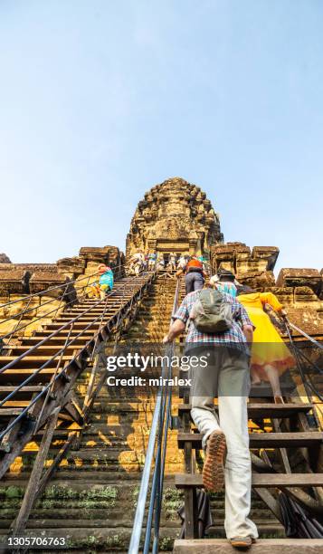 toerist die treden aan het heiligdom van de tempel angkor wat in cambodja beklimt - apsara stockfoto's en -beelden