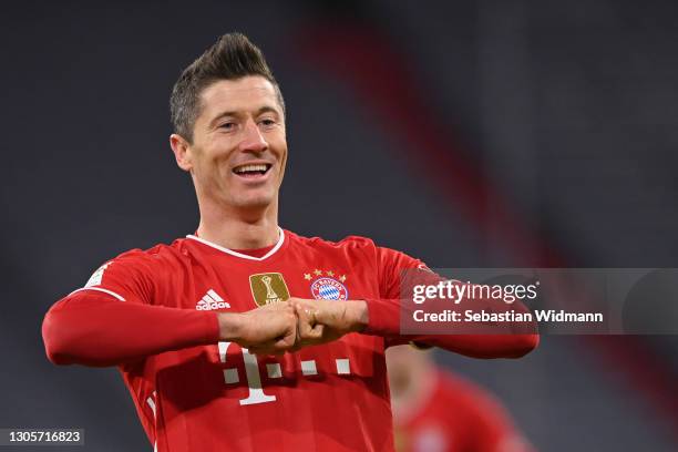 Robert Lewandowski of Bayern Muenchen celebrates after scoring his team's fourth goal during the Bundesliga match between FC Bayern Muenchen and...