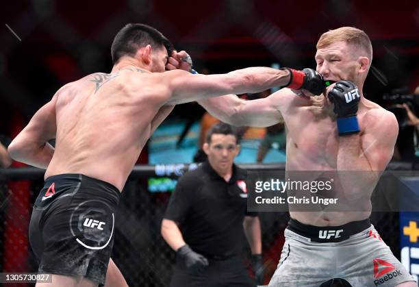 Dominick Cruz punches Casey Kenney in their bantamweight fight during the UFC 259 event at UFC APEX on March 06, 2021 in Las Vegas, Nevada.