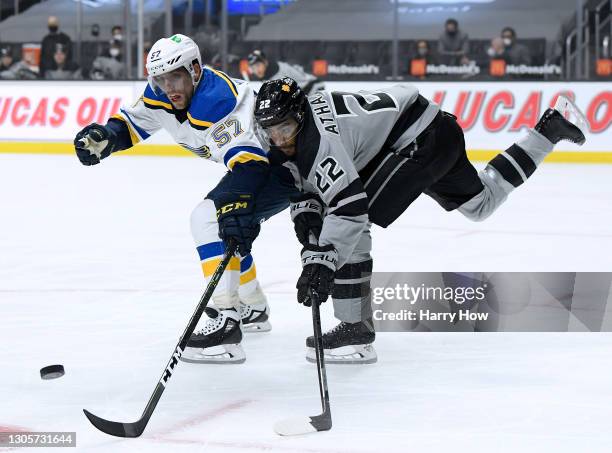 David Perron of the St. Louis Blues and Andreas Athanasiou of the Los Angeles Kings reach for the puck during the first period at Staples Center on...