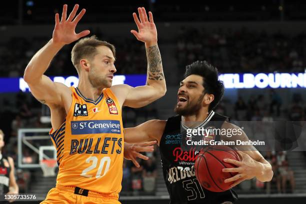Shea Ili of United drives at the basket under pressure from Nathan Sobey of the Bullets during the NBL Cup match between Melbourne United and the...