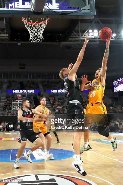 Nathan Sobey of the Bullets drives to the basket under pressure from Jock Landale of Melbourne United during the NBL Cup match between Melbourne...
