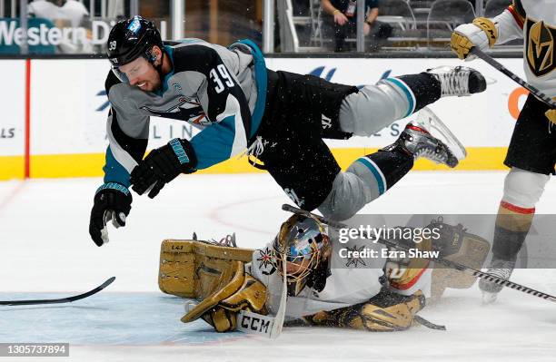 Logan Couture of the San Jose Sharks flies over goalie Marc-Andre Fleury of the Vegas Golden Knight after he is pushed by Chandler Stephenson in the...