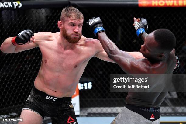 Jan Blachowicz of Poland punches Israel Adesanya of Nigeria in their UFC light heavyweight championship fight during the UFC 259 event at UFC APEX on...