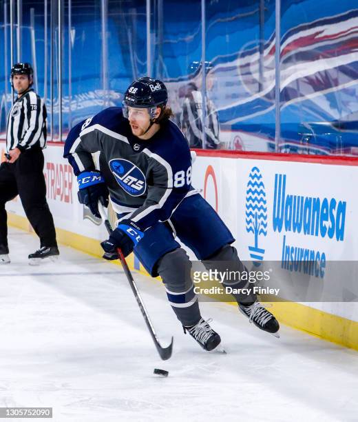 Nathan Beaulieu of the Winnipeg Jets plays the puck during first period action against the Vancouver Canucks at Bell MTS Place on March 02, 2021 in...