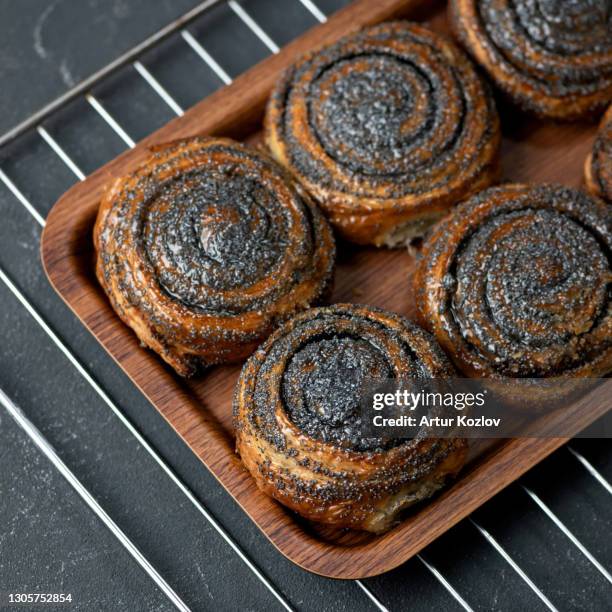 sweet buns with poppy seeds fresh from the oven. pastries, dessert food. delicious morning concept. square format or 1x1 for posting on social media - poppy seed stock-fotos und bilder