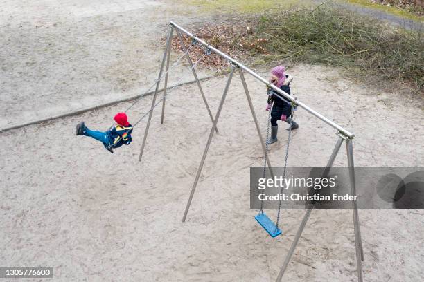 In this aerial view from a drone, the photographer's son enjoys the swings in a playground during the second wave of the coronavirus pandemic on...