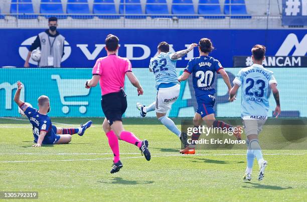 Santi Mina of Celta Vigo scores their side's first goal during the La Liga Santander match between SD Huesca and RC Celta at Estadio El Alcoraz on...