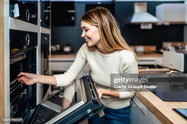young couple in shopping - major household appliance stock pictures, royalty-free photos & images