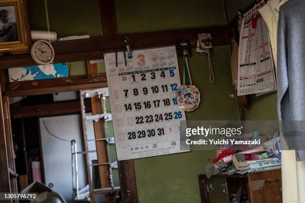 Calendar that still reads March 2011 hangs on a wall on March 7, 2021 in Futaba, Japan. In ceremonies that are expected to be scaled back because of...