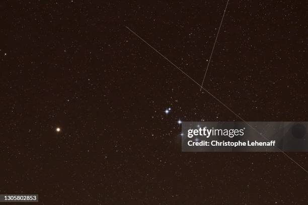 exceptional image showing starlink artificial satellites, planet mars and stars cluster the pleiades - pleiades stock pictures, royalty-free photos & images