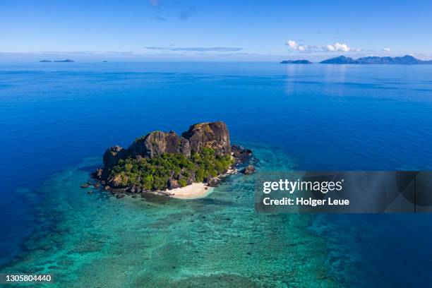 aerial of vomo lailai island with islands of the yasawa group in the distance - vomo fiji stock pictures, royalty-free photos & images