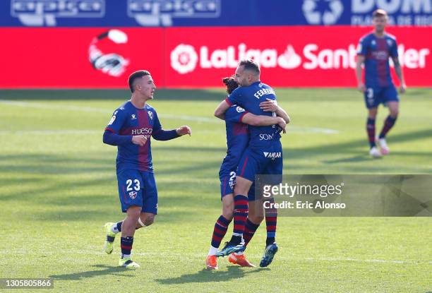 David Ferreiro of SD Huesca celebrates with Dani Escriche and team mates after scoring their side's third goal during the La Liga Santander match...
