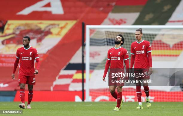 Mohamed Salah of Liverpool looks dejected with team mates Georginio Wijnaldum and Rhys Williams after Fulham's first goal scored by Mario Lemina...