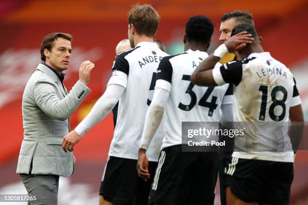 Scott Parker , Manager of Fulham congratulates his players after victory in the Premier League match between Liverpool and Fulham at Anfield on March...