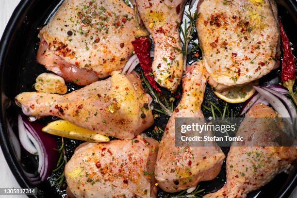 raw uncooked chicken legs with spices and ingredients for cooking - marinated stock pictures, royalty-free photos & images