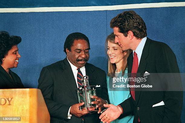 From left to right: Judge Charles Pierce receives this year's Profile In Courage award from Caroline Kennedy and John Kennedy, Jr. During today's...