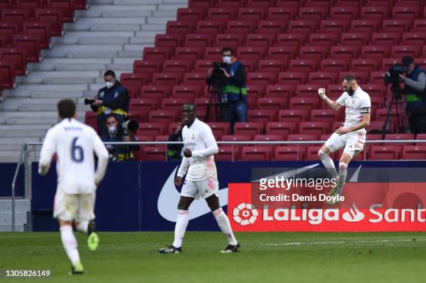 Karim Benzema of Real Madrid celebrates after scoring their side's first goal during the La Liga Santander match between Atletico de Madrid and Real...