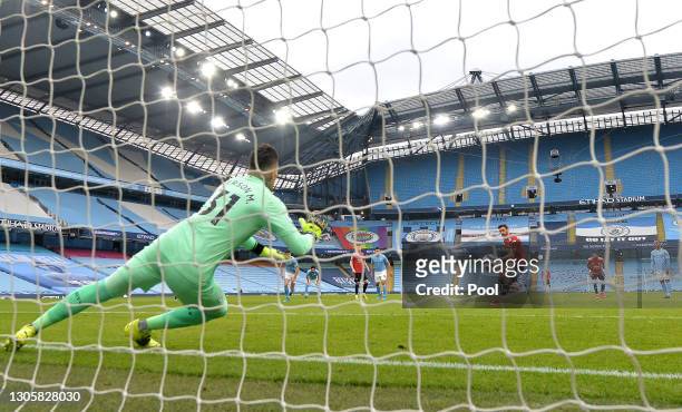Bruno Fernandes of Manchester United scores their side's first goal from the penalty spot past Ederson of Manchester City during the Premier League...