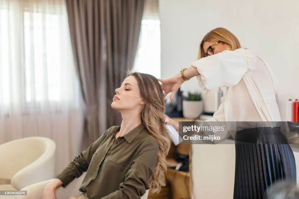 Beautiful woman at hair salon getting her hair done