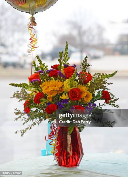 flower arrangement with balloon in a bright window - flower arrangement carnation ストックフォトと画像