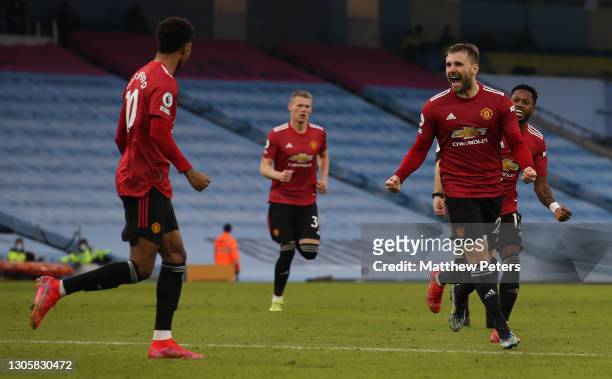 Luke Shaw of Manchester United celebrates scoring their second goal during the Premier League match between Manchester City and Manchester United at...