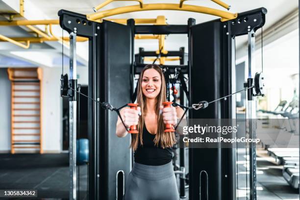 Premium Photo  Woman bodybuilder is working on her chest with cable  crossover in gym