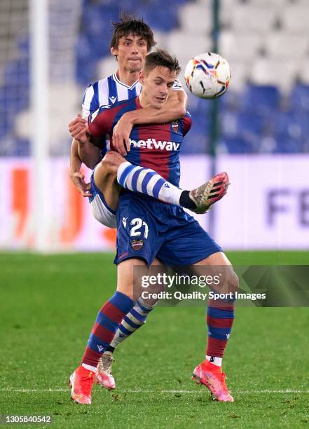 Robin Le Normand of Real Sociedad competes for the ball with Dani Gomez of Levante UD during the La Liga Santander match between Real Sociedad and...