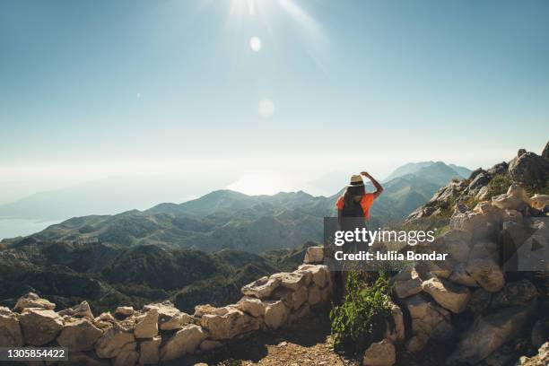 hiker with backpack crossing rocky terrain - aiming higher stock pictures, royalty-free photos & images