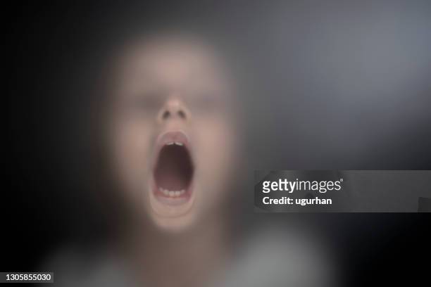 view of scared child through frosted glass - frosted window stock pictures, royalty-free photos & images
